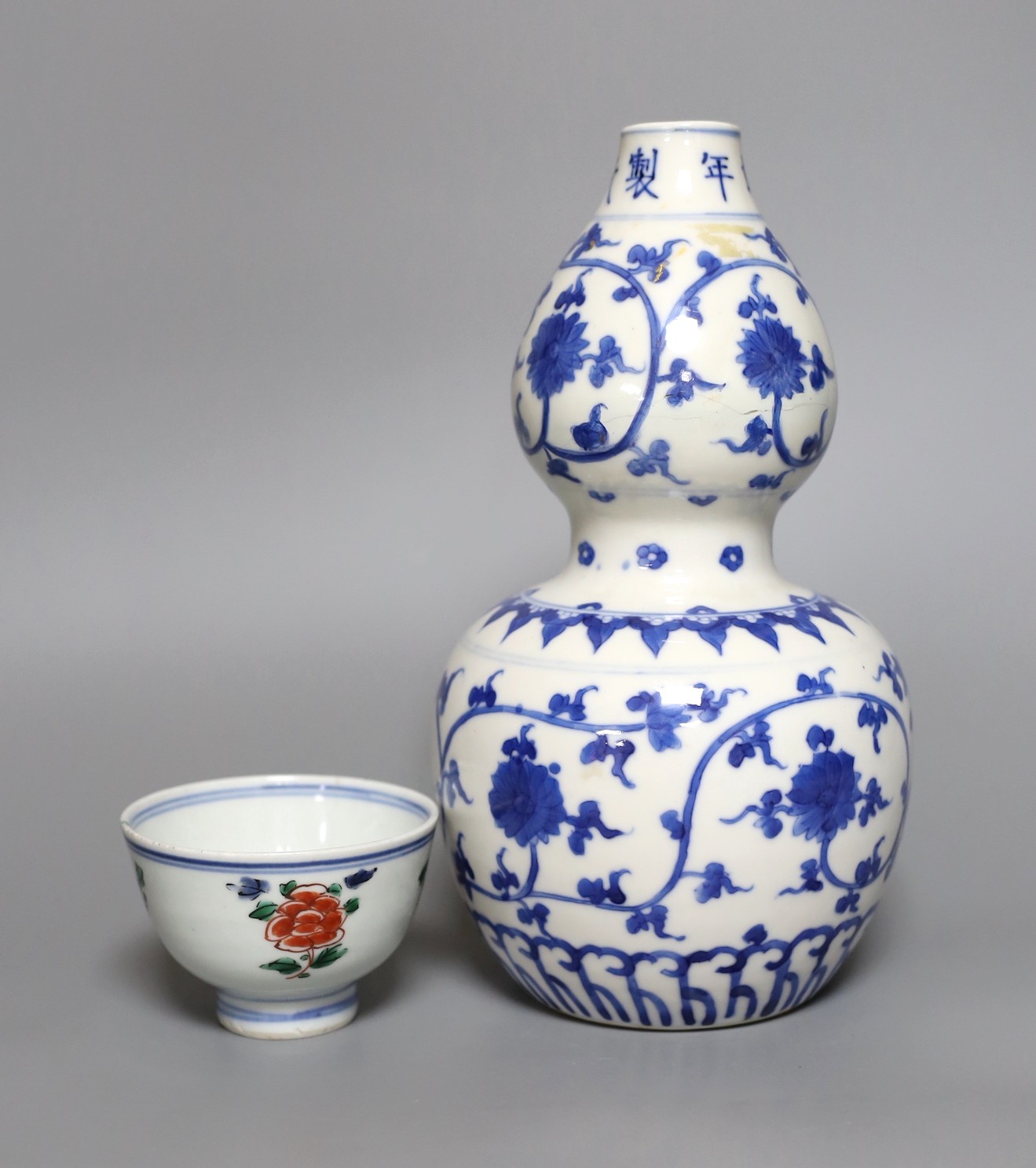 A Chinese blue and white double gourd vase, together with a Chinese famille verte bowl, tallest 25cm